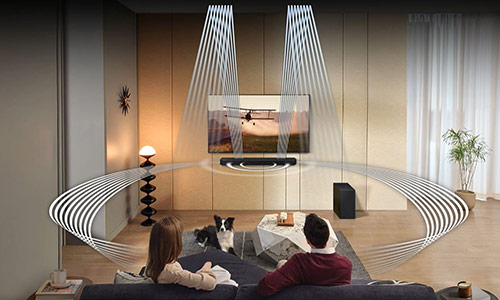 A man and woman are surrounded by sound waves that come out of the Q800C's front, side and up-firing speakers.