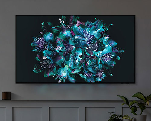 A TV is displaying a colorful flower-like pattern on its screen. The color details of the flower are very vivid.