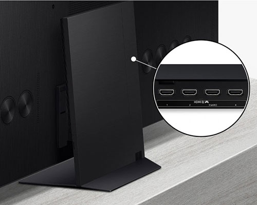 One Connect box attaches to the back of the TV stand. A close-up of the connection box shows 4 HDMI ports with a gaming icon and an eARC option.