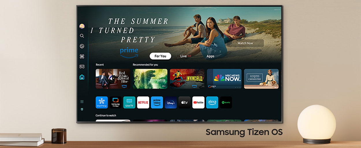 A wall-mounted TV shows popular apps and curated content on the home menu. Samsung Tizen OS