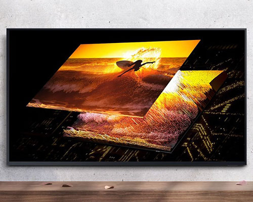 The Terrace TV hangs on a wall displaying a surfer on its screen. As the surfer image splits into two, it reveals Quantum Mini LEDs, accurately controlling the light.