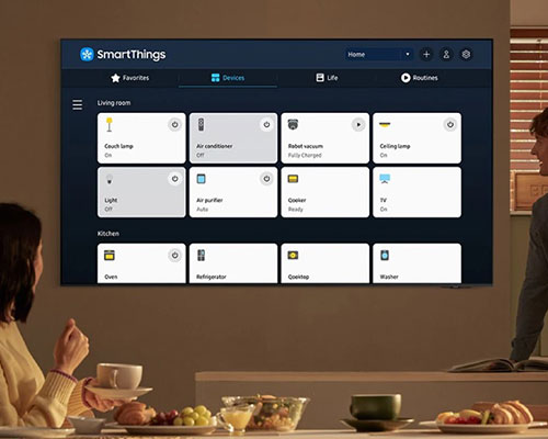 The TV displays SmartThings with various Living room and Kitchen devices connected to its built-in hub.